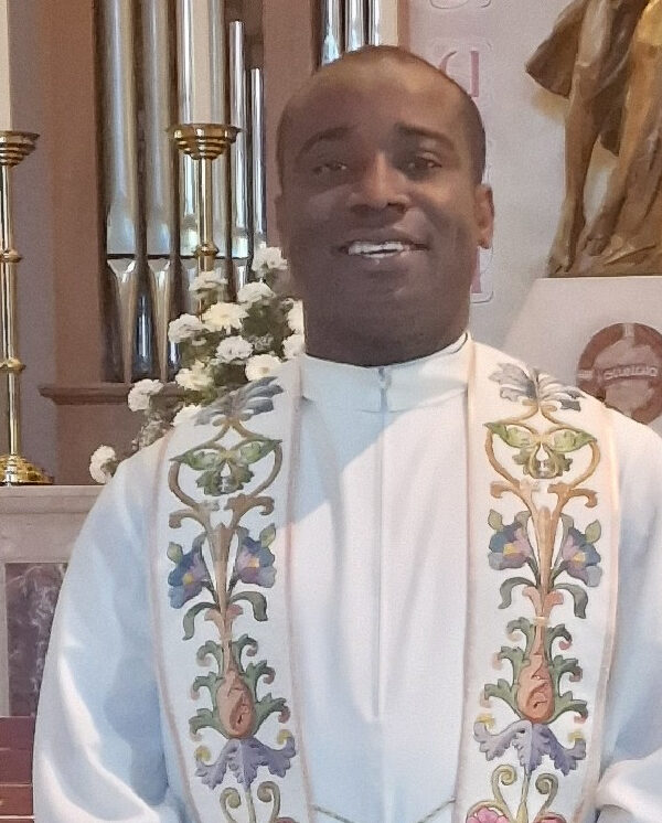 Fr Charles Ezejide, Assistant Priest, in white vestments